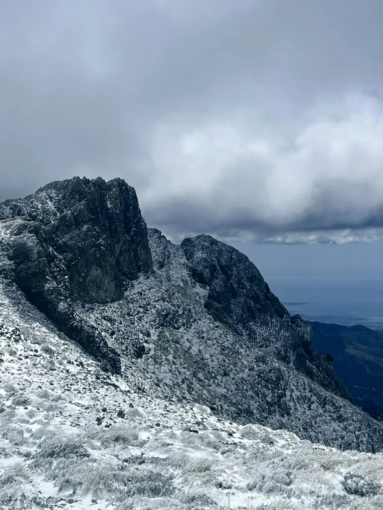 Crestas de roca nevadas bajo las nubes